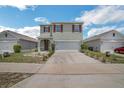 Charming two-story home with a two-car garage and well-maintained front yard at 129 Eagleview Loop, Davenport, FL 33837