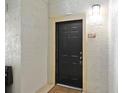 Apartment entrance with a black door and a 'Welcome' mat at 1321 Arbor Vista Loop # 301, Lake Mary, FL 32746