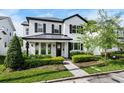 Beautiful two-story home with classic white siding, black shutters, and a neatly landscaped front yard at 1414 W New Hampshire St, Orlando, FL 32804