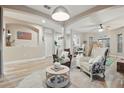 Spacious living room with modern decor, archways, light colored walls, and wood-look tile flooring at 15038 Masthead Landing Cir, Winter Garden, FL 34787