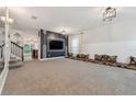 Open-concept living room featuring plush carpeting, large windows, and unique contemporary-style decor at 1961 Continental St, St Cloud, FL 34769