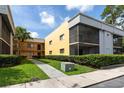 Apartment building with a lawn area and sidewalk entry leading to various units at 2627 Oak Park Way # 102, Orlando, FL 32822