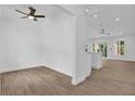 Spacious living area featuring wood-look tile floors, recessed lighting, and a ceiling fan at 300 Cherokee Ave, Orange City, FL 32763