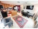 Eat-in kitchen with stainless steel appliances, an island, and an adjacent dining area at 312 W Hull Ave, Oakland, FL 34760