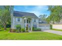 Beautiful two-story home features a well-kept lawn, a three-car garage, and neatly trimmed landscaping at 3231 Furlong Way, Gotha, FL 34734
