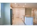 Modern kitchen features stainless steel appliances, granite countertops, and tile flooring at 3381 Sw 129Th Loop, Ocala, FL 34473