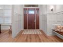 Elegant foyer featuring wood floors, paneled walls, and a stylish front door with glass inserts at 340 Lakeview Rd, Winter Garden, FL 34787