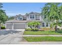 Charming two-story home featuring a well-manicured lawn, a three-car garage, and welcoming curb appeal at 384 Old Alemany Pl, Oviedo, FL 32765
