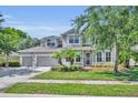Charming two-story home featuring a well-manicured lawn, a three-car garage, and welcoming curb appeal at 384 Old Alemany Pl, Oviedo, FL 32765