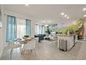 Open floor plan featuring modern decor, dining area, living room, and adjacent waterfall wall decor at 4363 Scene Ln, Kissimmee, FL 34746