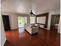 Bright living room with sliding glass doors, sleek wood floors and modern entertainment center at 4756 Walden Cir # 21, Orlando, FL 32811