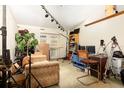 View of the cluttered living room with neutral walls, a ceiling fan, and bright, natural light at 4933 Round Lake Rd, Apopka, FL 32712