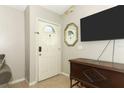 Entryway with a white front door, light gray walls, and tile floors at 519 Beasley Ct, Orlando, FL 32807