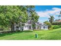 Beautifully landscaped home with solar panels on the roof, offering a blend of charm and modern efficiency at 5311 Saddleback Ct, Lady Lake, FL 32159