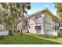 Exterior of the apartment buildings with lush landscaping and palm trees at 563 Midway Trak # K102, Ocala, FL 34472