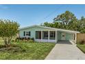 Beautiful one-story home featuring a covered carport and well-manicured lawn at 588 Highway 630 E, Frostproof, FL 33843