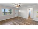 Bright living room with new floors, a ceiling fan and a front door at 588 Highway 630 E, Frostproof, FL 33843