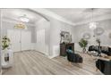 Elegant foyer with modern chandeliers, light wood floors, and stylish decor, creating a welcoming ambiance at 6426 Montclair Bluff Ln, Windermere, FL 34786
