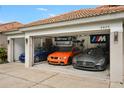 A spacious three-car garage with a collection of luxury automobiles, boasting ample space for car enthusiasts at 6426 Montclair Bluff Ln, Windermere, FL 34786
