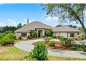 Elegant home showcases meticulously landscaped grounds and striking curb appeal at 9019 Tower Pine Dr, Winter Garden, FL 34787