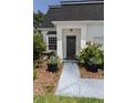 Inviting front entrance with a stylish black door and manicured landscaping at 907 Sussex Close # 4, Orlando, FL 32804