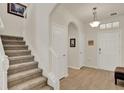 Welcoming foyer featuring wood-look tile flooring, a staircase, and neutral paint throughout at 11006 Sound Shore Dr, Winter Garden, FL 34787