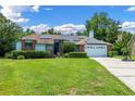 Charming single-story home with solar panels, lush landscaping, and a two-car garage at 1032 Silcox Branch Cir, Oviedo, FL 32765