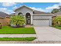 Lovely single-Gathering home boasting a manicured lawn, lush landscaping, and an attached two-car garage at 1035 Stoney Creek Dr, Lakeland, FL 33811