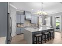This modern kitchen features stainless steel appliances, an island with bar seating, and lots of natural light at 1035 Stoney Creek Dr, Lakeland, FL 33811