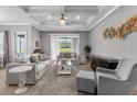 Sun-filled living room featuring a tray ceiling, neutral color palette, and lots of comfortable seating at 1035 Stoney Creek Dr, Lakeland, FL 33811