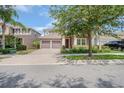 Exterior view of home with a two-car garage and attractive landscaping at 13940 Magnolia Ridge Loop, Winter Garden, FL 34787