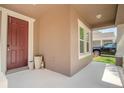 Covered front porch with a charming entryway and neutral color scheme at 13940 Magnolia Ridge Loop, Winter Garden, FL 34787