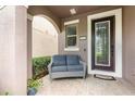 Inviting front porch features a comfortable seating area, a stylish front door with a glass panel, and a welcoming atmosphere at 14215 Lakeview Park Rd, Winter Garden, FL 34787