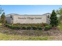 Welcome to Osceola Village Center, a beautiful community. Landscaped entrance with stone monument at 1518 Isleta Loop, Kissimmee, FL 34741