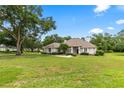 Beautiful home with lush lawn and landscaping on a sunny day with mature trees at 1700 Shandwick Ct, Longwood, FL 32779