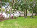 Serene backyard with lush green lawn, white vinyl fencing, and charming garden bench at 1701 Lucky Pennie Way, Apopka, FL 32712