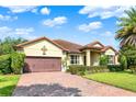 Beautifully landscaped front yard leads to this one-story home with brick driveway and tiled roof at 172 Verde Way, Debary, FL 32713