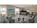 Open-concept living space featuring modern decor, a kitchen island, and a dining area at 17441 Hidden Forest Dr, Clermont, FL 34714