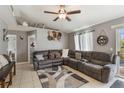 Cozy living room featuring a sectional sofa, ceiling fan, and sliding doors to the outdoors at 1785 6Th Ave, Deland, FL 32724