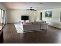 Spacious living room featuring modern flooring, a ceiling fan and a large sliding glass door at 1809 Pepperidge Dr, Orlando, FL 32806