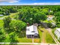 Aerial view of the home showcasing its large lot, mature trees, and proximity to local amenities at 1826 W Silver Springs Blvd, Ocala, FL 34475