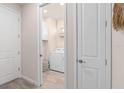 Convenient laundry room with a modern washer and dryer, storage cabinet, and stylish decor at 2334 Daisy Tree Rd, St Cloud, FL 34771
