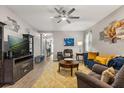 Spacious living area with a ceiling fan, plush seating, and a view into the entry, ideal for entertaining at 2417 Liner Ave, Apopka, FL 32703