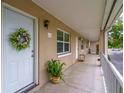 A condo front door with a wreath is accented by potted plants and the walkway to the entrance at 2500 Lee Rd # 243, Winter Park, FL 32789