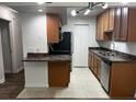 Well-lit kitchen with stainless steel appliances, granite counters, and ample cabinet space at 3120 Plaza Terrace Dr # 3120, Orlando, FL 32803