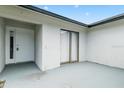 Covered entrance patio with modern door and sliding glass door, offering an inviting outdoor space at 3187 Shady Willow Dr, Orlando, FL 32808