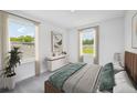 Bright bedroom with neutral tones, two large windows, and stylish furnishings creating a relaxing atmosphere at 33313 Country House Dr, Sorrento, FL 32776