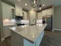 Modern kitchen featuring white cabinets, stainless steel appliances, and a large island with sink at 368 Birkdale Dr, Daytona Beach, FL 32124