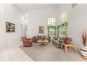 Bright living room with high ceilings, large windows, and neutral decor at 4026 S Lake Orlando Pkwy, Orlando, FL 32808