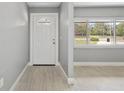 Bright entryway featuring wood-look tile flooring and a decorative front door with sidelight window at 4116 Sw 20Th St, Ocala, FL 34474